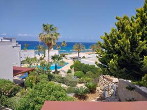 a view of a resort with the ocean in the background at Villa Margo by the Sea in Paphos