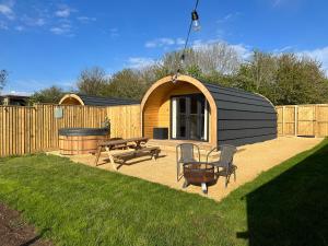 a backyard with a shed with a picnic table and a bench at Lois' Pod with Hot Tub, Near Airport in Bristol
