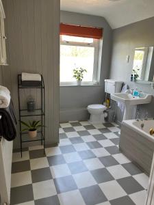 a bathroom with a black and white checkered floor at Field View in Oakham