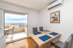 a small dining room with a table and a balcony at Luxury Apartment Maglica in Makarska