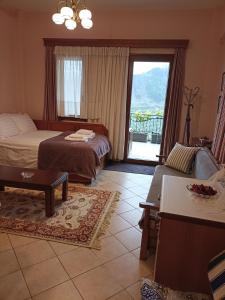 a hotel room with two beds and a balcony at LOUNA in Metsovo