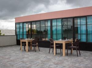 a group of tables and chairs in front of a building at West Star Hotel in Kutaisi