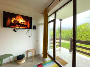 a living room with a fireplace in a house at Cozy Riverfront Apartments with garden and mountain view in Buşteni