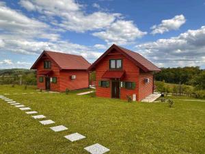 a red house in the middle of a field at Resort Dudukovic 1 in Slunj