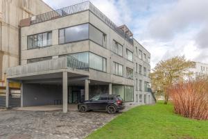 a car parked in front of a building at Bronze Colour Studio in Tartu City Centre in Tartu