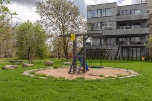 a playground in a park in front of a building at Bronze Colour Studio in Tartu City Centre in Tartu