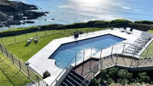 an overhead view of a swimming pool next to the ocean at Watersmeet Hotel in Woolacombe