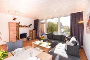a living room with a couch and a table at Golfresidenz Whg A14 in Grömitz