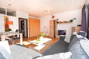 a living room with a couch and a table at Golfresidenz Whg A14 in Grömitz