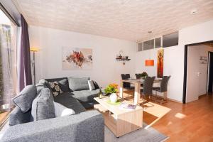 a living room with a couch and a table at Golfresidenz Whg A14 in Grömitz
