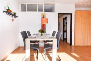 a dining room with a table and chairs at Golfresidenz Whg A14 in Grömitz +12 photos
