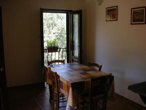 a table and chairs in a room with a window at Agriturismo Torre Rinusa in Pietrapaola