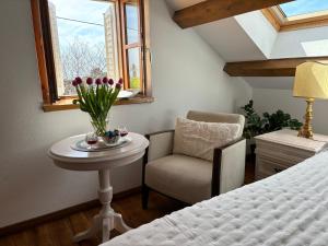 a bedroom with a table and a chair and a bed at Villa Anica Dubrovnik in Dubrovnik