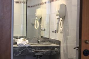 
a bathroom with a sink and a mirror at Hotel Villa Igea in Diano Marina
