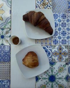 a plate of food with a pastry on a table at Mezza Torre B&B in Procida