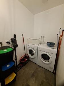 a laundry room with a washing machine and a camera at Les abeilles du Mont d'or in Manosque