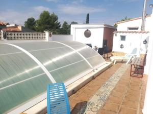 a pool on the roof of a house at Tiny house in Puebla de Vallbona