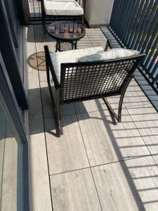 a balcony with a bench and a table at Upper executive apartment in Dagenham