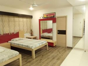 a bedroom with two beds and a mirror at Entire Bungalow In Karachi in Karachi