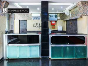a kitchen with blue cabinets in a restaurant at Collection O Heritage VIP Road in Kolkata