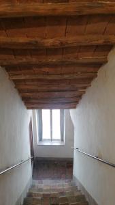 an attic room with a wooden ceiling and a window at La Casetta di Mimmi in Castel Viscardo