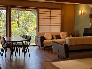 a living room with a couch and a table at 風まち in Yawatano