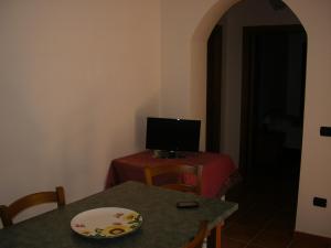 a room with a table with a computer on top of it at Agriturismo Torre Rinusa in Pietrapaola