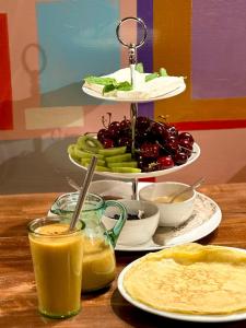 a table with a plate of food and a tray of fruits and vegetables at Lavanda Restaurant with Rooms in Kovachevitsa