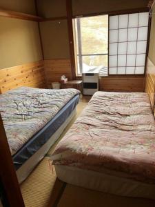 Postel nebo postele na pokoji v ubytování Futago Cabin