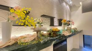 a counter with flowers and vases on it at Richmond Hotel Akita Ekimae in Akita