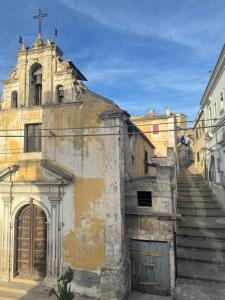an old building with a cross on top of it at B&B Sicily O'Clock Room in Lentini