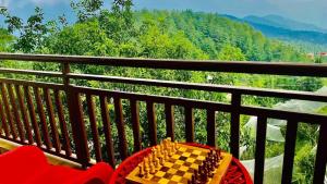 a chess board on a table on a balcony at Hotel Radian regency - Family Vacations - Tasty Food - Parking Space and Top Rated Property in KUFRI in Shimla