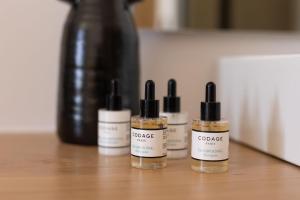 a group of three bottles of essential oils on a table at Olive Vista Suites in Kastraki