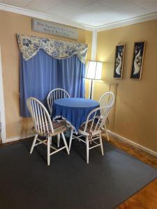 a dining room table with chairs and a blue table at LITTLE SANDY-LIMIT 8 cottage in North Sebago