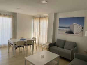 a living room with a couch and a table at Apartamento ático en Denia in Denia