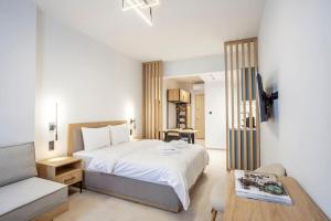 a bedroom with a bed and a table and a couch at FsN Central Lofts 301 / 3P in Thessaloniki