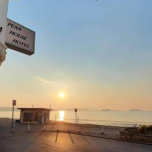 a sign for a ferry house hotel in front of the water at Penn House Hotel in Weymouth +60 photos