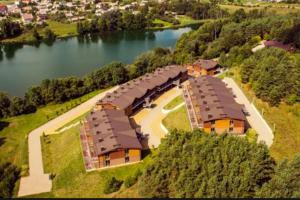 an aerial view of a house next to a lake at The best apartment in Trakai! Retreat! Rejuvenate! Rent with Ease! in Trakai