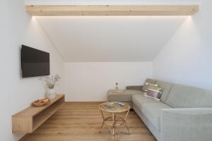 a living room with a couch and a table at Untermairhof in Lagundo