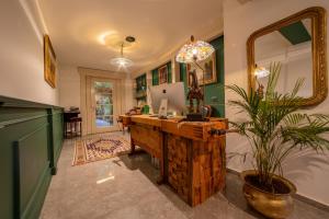 a home office with a desk and a mirror at Doa Boutique Hotel in Peje