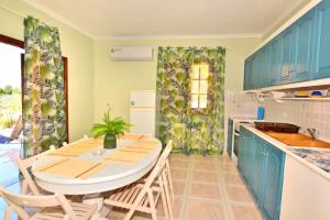 a kitchen with a table and chairs in a room at Emma's Studios in Lassi