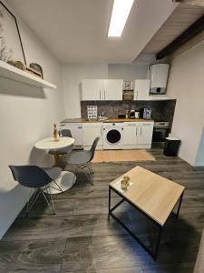 a kitchen with a table and chairs in a room at Apartmán YASNE in Ostrava