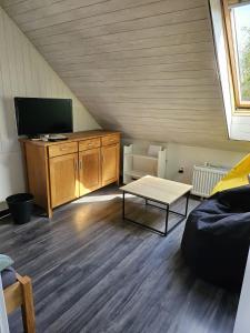 a living room with a tv and a table at Apartmán YASNE in Ostrava