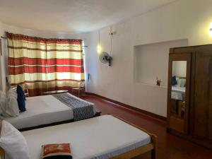 Postel nebo postele na pokoji v ubytování Kandy Siebel Bungalow + 15 fotografií