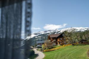 a view from a window of a house with a snow covered mountain at Haus Widdersteinblick in Riezlern