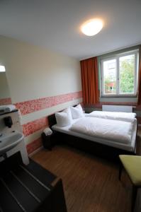 Ένα ή περισσότερα κρεβάτια σε δωμάτιο στο HOLI City Apart Hotel Berlin