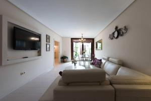 a living room with a couch and a flat screen tv at Casa Rural Bellamonte in Belmonte +58 photos