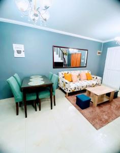 a living room with a couch and a table at Charming Duplex Apartment in Tagbilaran City