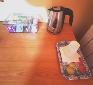 a table with a tea kettle and a cup on it at Porto Recanati Zimmer in Porto Recanati