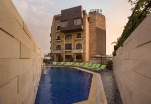 a swimming pool in front of a building at Opera Hotel 